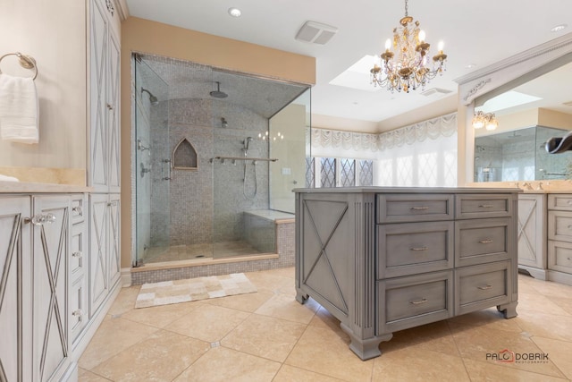bathroom featuring a chandelier, a shower stall, tile patterned flooring, and vanity