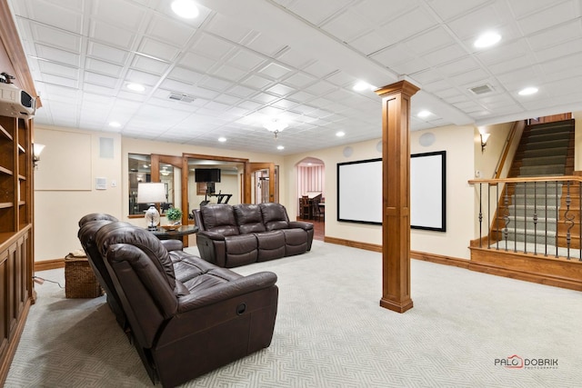 living area featuring stairway, arched walkways, baseboards, carpet flooring, and visible vents