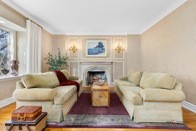 living area featuring a high end fireplace, baseboards, ornamental molding, and wood finished floors