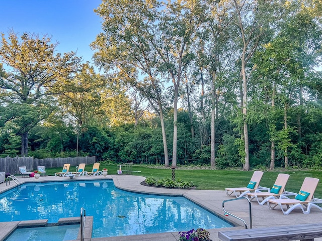 view of swimming pool with a yard, a patio area, a pool with connected hot tub, and fence