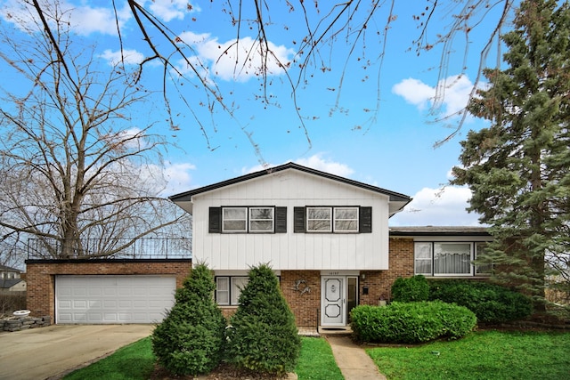 16157 Ozark Ave, Tinley Park, IL 60477 - split level home with an attached garage, driveway, and brick siding