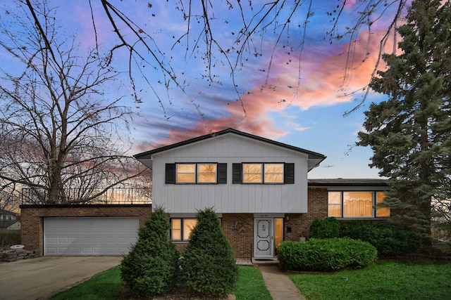 16157 Ozark Ave, Tinley Park, IL 60477 - split level home featuring an attached garage, brick siding, and concrete driveway