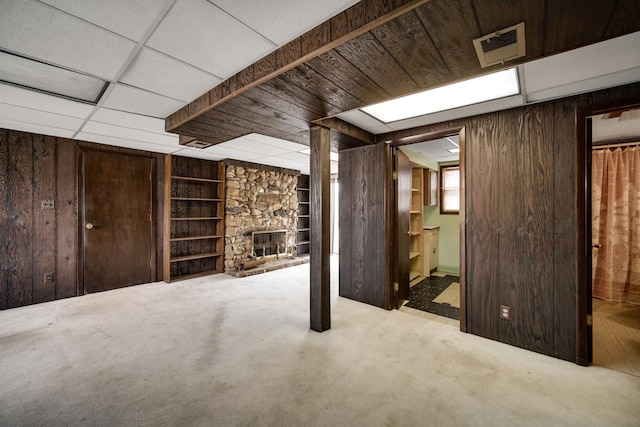16157 Ozark Ave, Tinley Park, IL 60477 - basement with a stone fireplace, visible vents, wood walls, and built in shelves