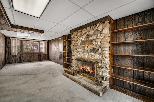16157 Ozark Ave, Tinley Park, IL 60477 - unfurnished living room featuring wood walls, built in features, a fireplace, a paneled ceiling, and carpet flooring