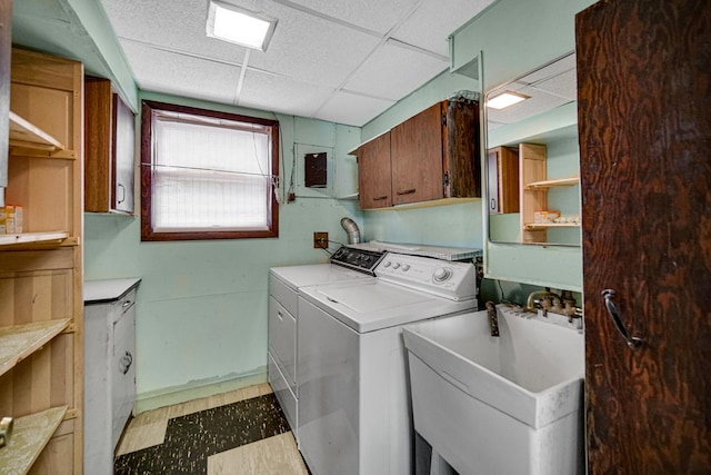 16157 Ozark Ave, Tinley Park, IL 60477 - washroom with a sink, baseboards, cabinet space, light floors, and washer and dryer