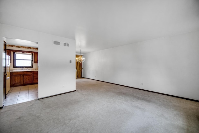 16157 Ozark Ave, Tinley Park, IL 60477 - unfurnished room featuring light colored carpet, a chandelier, a sink, and visible vents