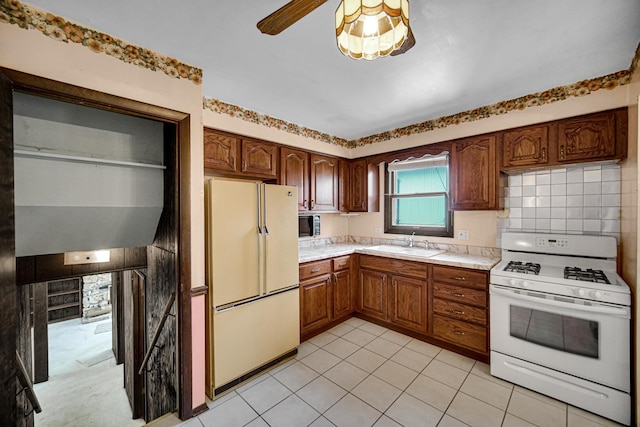 16157 Ozark Ave, Tinley Park, IL 60477 - kitchen with a sink, white appliances, ceiling fan, light countertops, and light tile patterned floors
