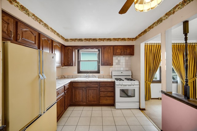 16157 Ozark Ave, Tinley Park, IL 60477 - kitchen featuring a sink, backsplash, a ceiling fan, white appliances, and light countertops