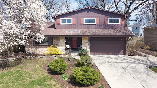 view of front facade with board and batten siding, driveway, roof with shingles, a garage, and brick siding