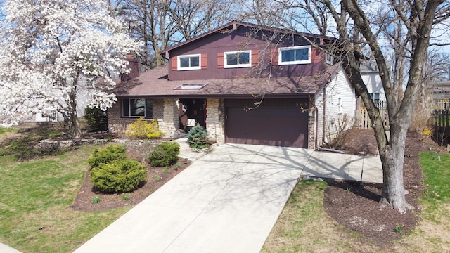 view of front of home with a front lawn, fence, a shingled roof, concrete driveway, and an attached garage