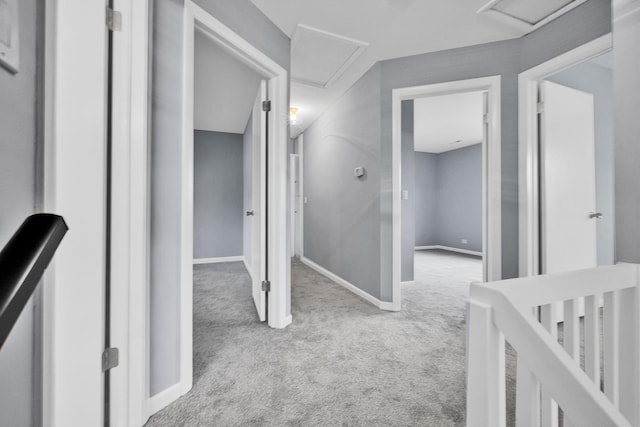 hall with baseboards and carpet