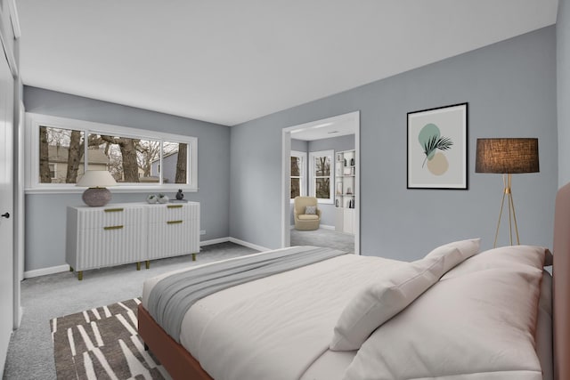 bedroom featuring carpet floors, baseboards, and radiator