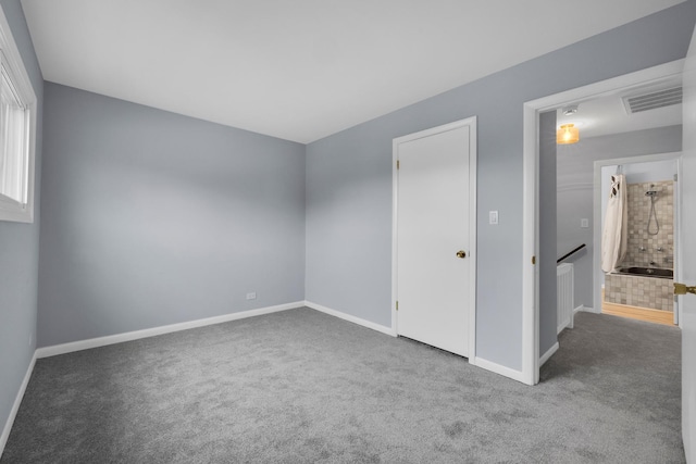 unfurnished bedroom featuring baseboards, carpet, and visible vents