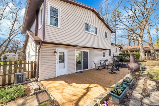 back of house with fence, a wooden deck, cooling unit, and outdoor dining space