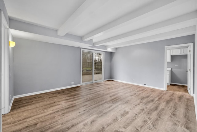 unfurnished bedroom featuring baseboards, access to outside, beamed ceiling, and wood finished floors