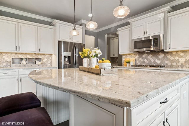 32 E Peter Ln, Hawthorn Woods, IL 60047 - kitchen featuring appliances with stainless steel finishes, a kitchen island, backsplash, light stone countertops, and white cabinets