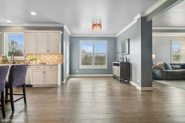 32 E Peter Ln, Hawthorn Woods, IL 60047 - kitchen with ornamental molding, dark wood-type flooring, open floor plan, light countertops, and decorative backsplash