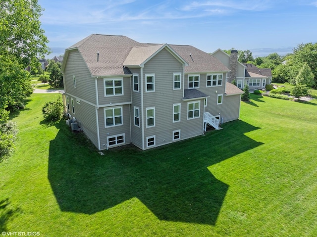 32 E Peter Ln, Hawthorn Woods, IL 60047 - rear view of house featuring a chimney, roof with shingles, and a yard
