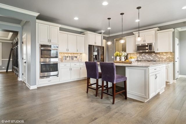 32 E Peter Ln, Hawthorn Woods, IL 60047 - kitchen with stainless steel appliances, ornamental molding, backsplash, a center island, and white cabinetry