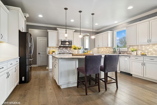 32 E Peter Ln, Hawthorn Woods, IL 60047 - kitchen with appliances with stainless steel finishes, a center island, white cabinets, ornamental molding, and recessed lighting