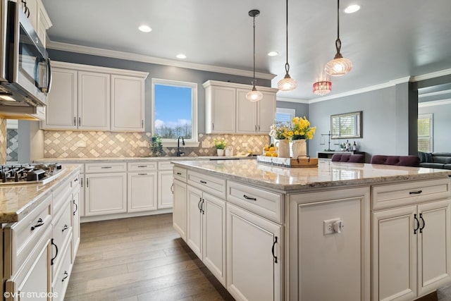32 E Peter Ln, Hawthorn Woods, IL 60047 - kitchen with stainless steel appliances, a kitchen island, crown molding, decorative backsplash, and open floor plan