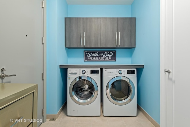 435 N Michigan Ave Unit 401, Chicago, IL 60611 - washroom with cabinet space, baseboards, light tile patterned flooring, and washer and clothes dryer