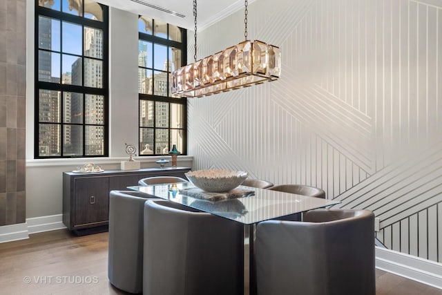 435 N Michigan Ave Unit 401, Chicago, IL 60611 - dining room featuring wood finished floors, crown molding, baseboards, a notable chandelier, and a view of city