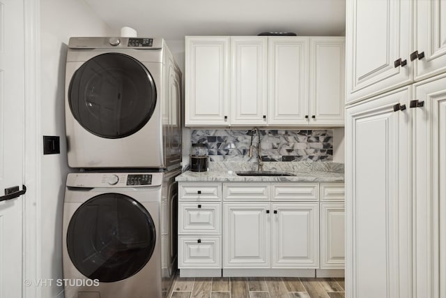 7267 Southwick Dr, Frankfort, IL 60423 - laundry room with stacked washer / drying machine, light wood finished floors, cabinet space, and a sink