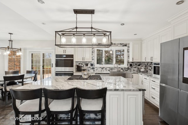 7267 Southwick Dr, Frankfort, IL 60423 - kitchen with stainless steel appliances, a sink, a kitchen island, light stone countertops, and tasteful backsplash