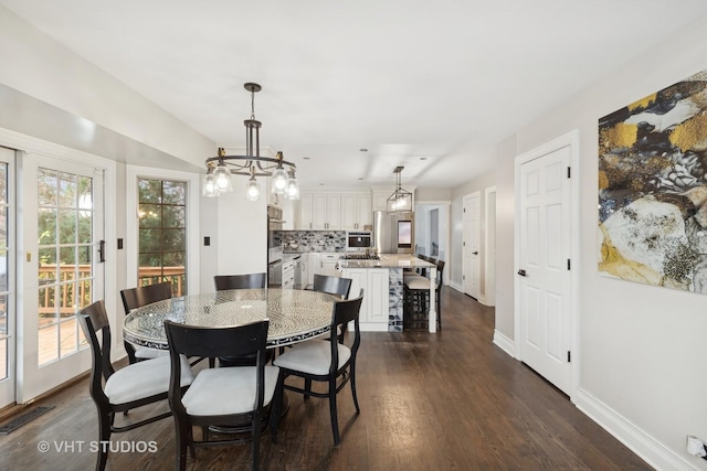 7267 Southwick Dr, Frankfort, IL 60423 - dining room featuring a notable chandelier, visible vents, baseboards, and dark wood-style flooring
