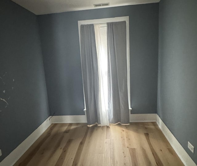 554 Spring St, Aurora, IL 60505 - unfurnished room with wood finished floors, visible vents, and baseboards