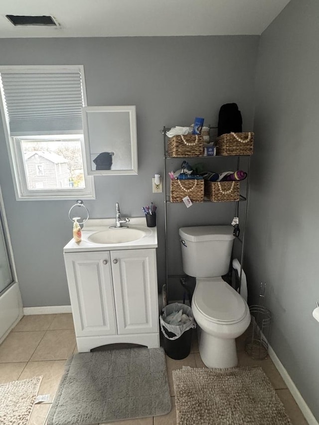 554 Spring St, Aurora, IL 60505 - full bathroom with vanity, toilet, tile patterned flooring, and baseboards