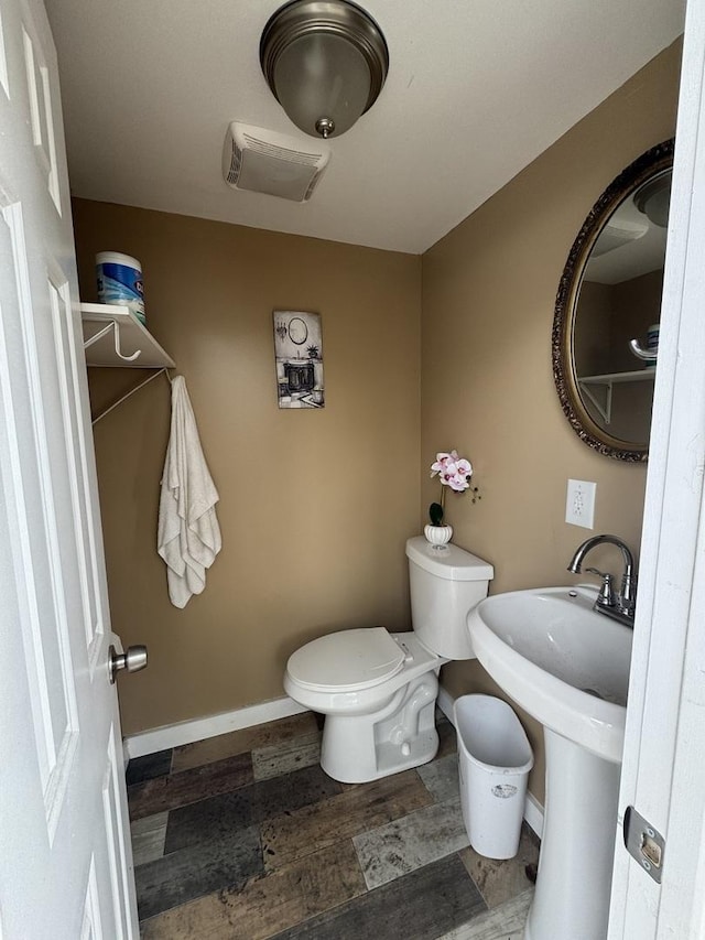 554 Spring St, Aurora, IL 60505 - bathroom with wood finished floors, visible vents, toilet, and baseboards