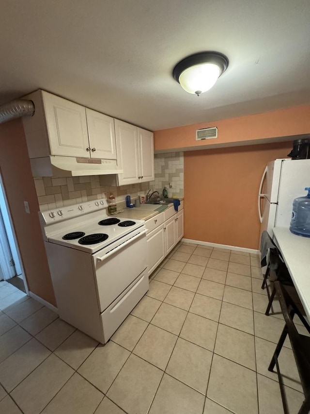 554 Spring St, Aurora, IL 60505 - kitchen with under cabinet range hood, visible vents, white appliances, and light countertops