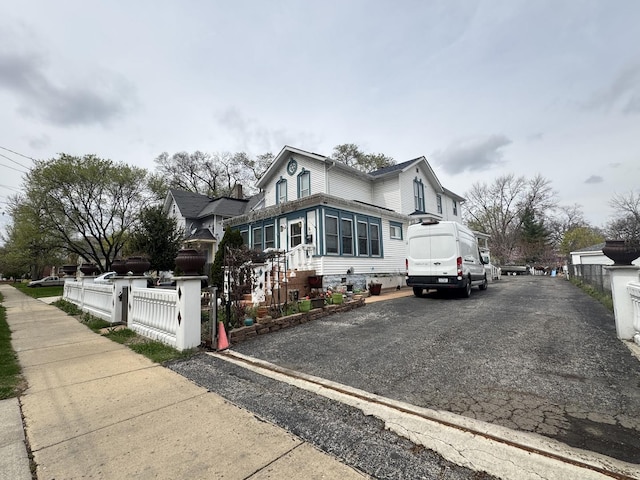554 Spring St, Aurora, IL 60505 - view of front of house featuring aphalt driveway and a fenced front yard