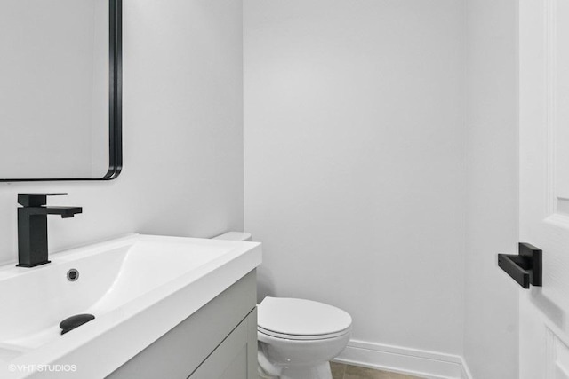 23726 N Overhill Dr, Lake Zurich, IL 60047 - half bathroom featuring baseboards, toilet, and vanity