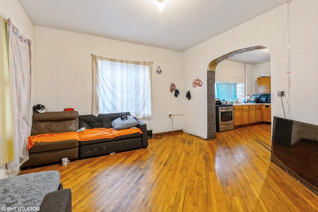 1733 N Keating Ave, Chicago, IL 60639 - living room featuring arched walkways and light wood finished floors