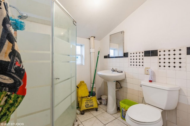 1733 N Keating Ave, Chicago, IL 60639 - bathroom featuring a shower stall, toilet, tile patterned floors, a sink, and tile walls