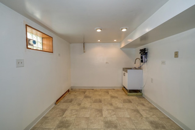 laundry area with baseboards, recessed lighting, and stone finish floors