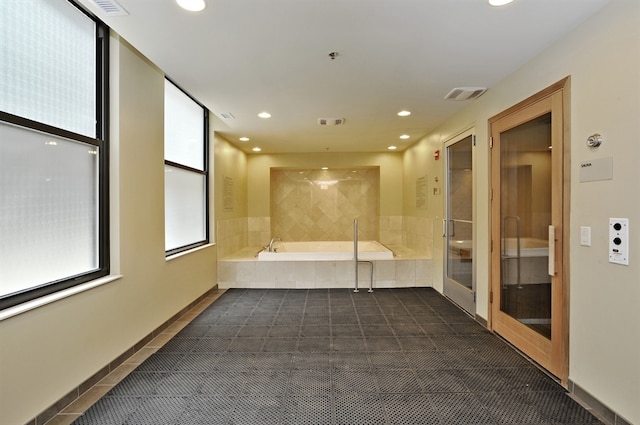 unfurnished room featuring dark tile patterned floors, recessed lighting, and fire sprinkler in ceiling