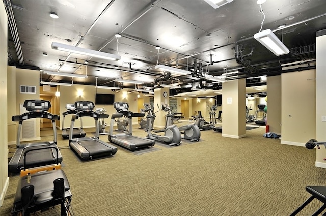 workout area featuring carpet floors and baseboards