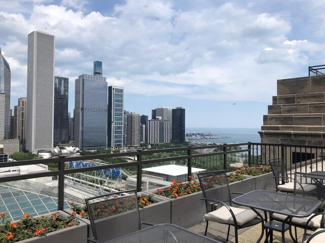balcony featuring a water view and a view of skyline
