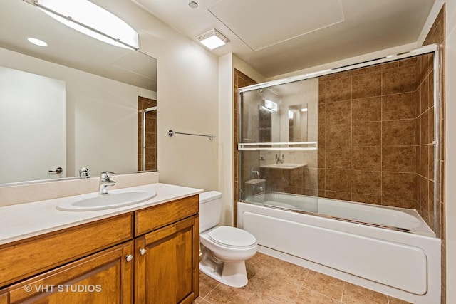 bathroom featuring toilet, shower / bath combination with glass door, vanity, and tile patterned flooring