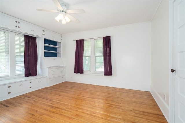 316 E Pierce St, Pontiac, IL 61764 - spare room featuring crown molding, light wood finished floors, healthy amount of natural light, a ceiling fan, and baseboards
