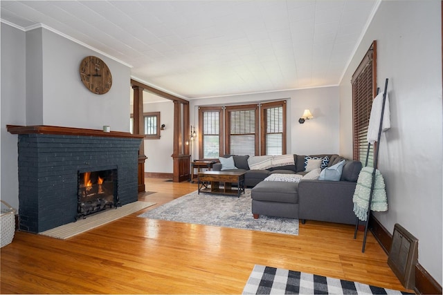 316 E Pierce St, Pontiac, IL 61764 - living room featuring a fireplace, ornamental molding, wood finished floors, and baseboards