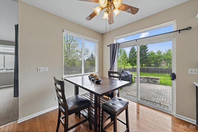 dining room with baseboards, ceiling fan, and wood finished floors