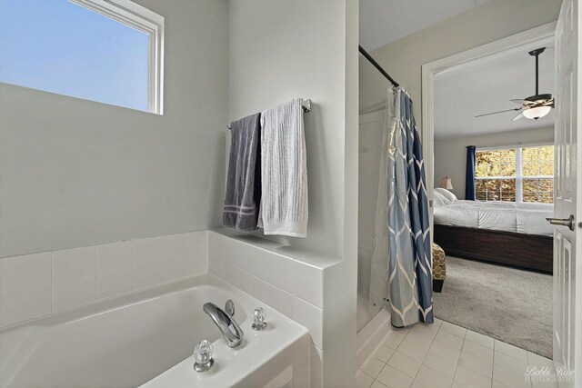 ensuite bathroom featuring a ceiling fan, a bath, a shower stall, tile patterned floors, and ensuite bathroom