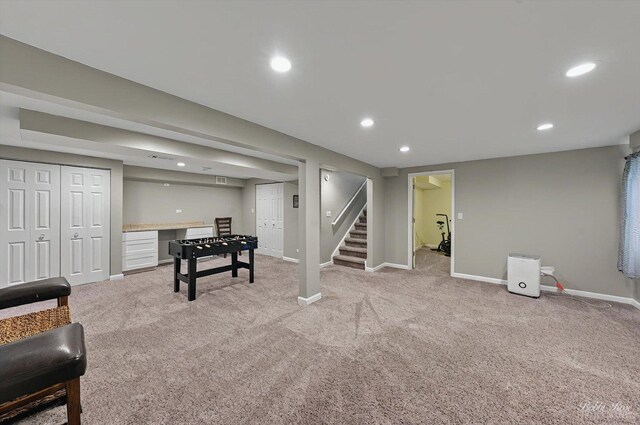 recreation room featuring baseboards, light carpet, and recessed lighting