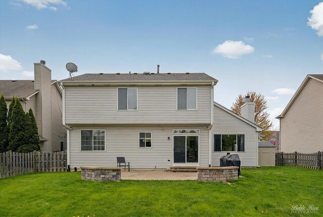 back of property with a yard, a patio, and a fenced backyard