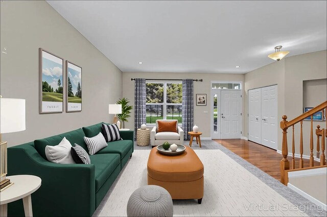 living area featuring baseboards, recessed lighting, stairs, and wood finished floors